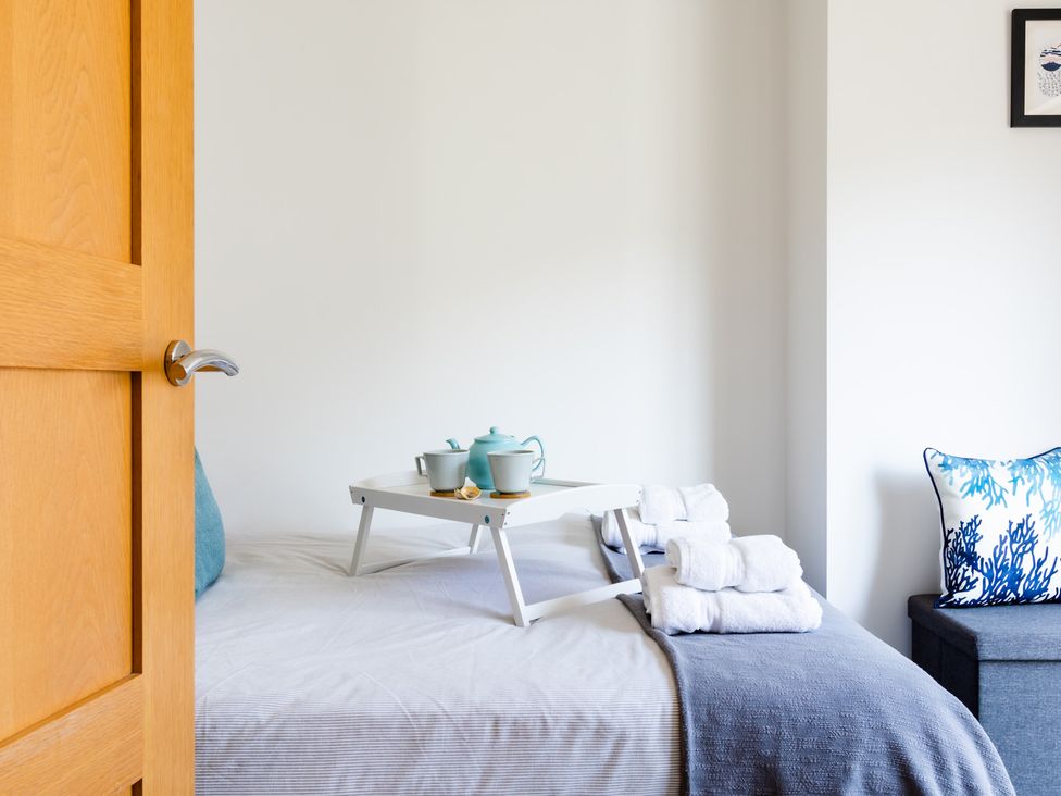 A bedroom with a bed and a serving tray at 11A Cards Wynd Anstruther