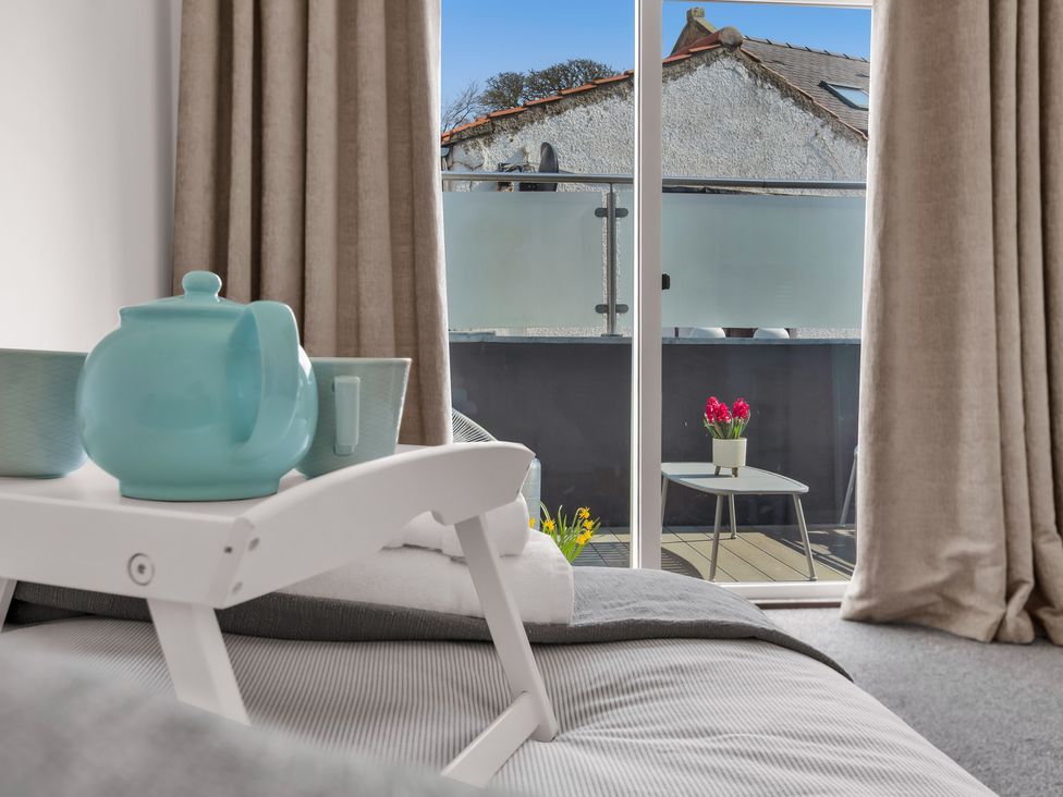 A living room with a teapot and cup on a table at 11A Cards Wynd in Anstruther