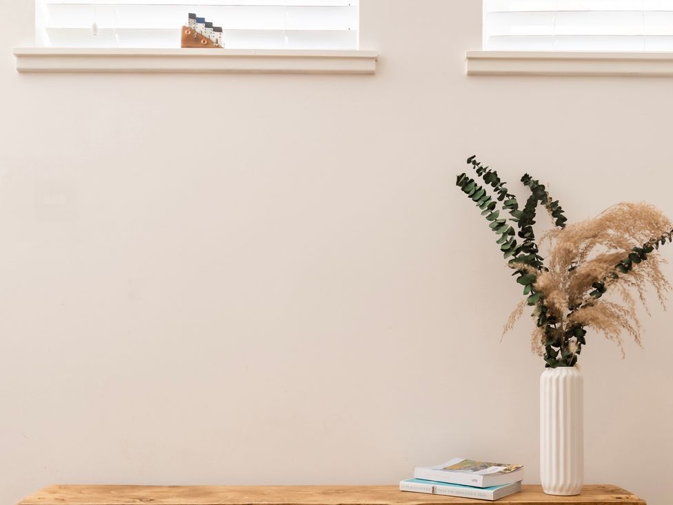 A table with a vase and books at 11A Cards Wynd in Anstruther