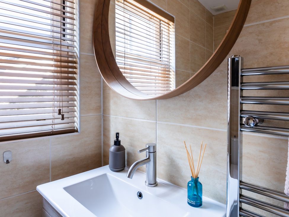 A bathroom with a sink and mirror at 11A Cards Wynd Anstruther