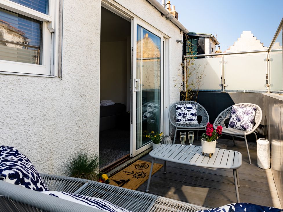 An outdoor area with chairs and a table at 11A Cards Wynd in Anstruther