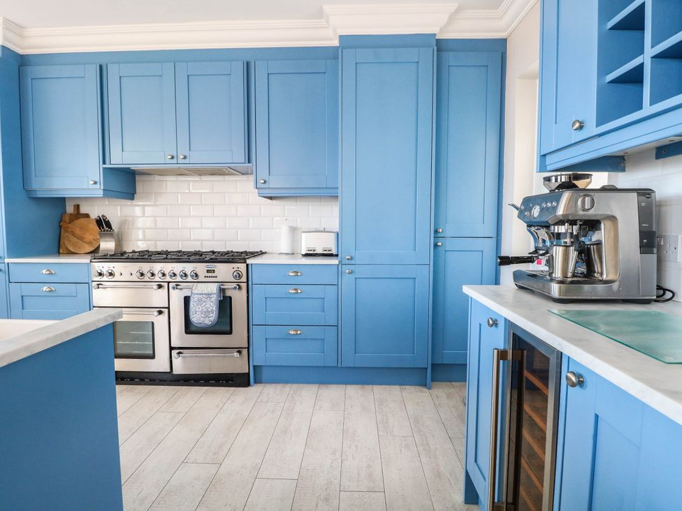 A kitchen with blue cabinets and stainless steel appliances at Cootiya Corner in Great Lyth