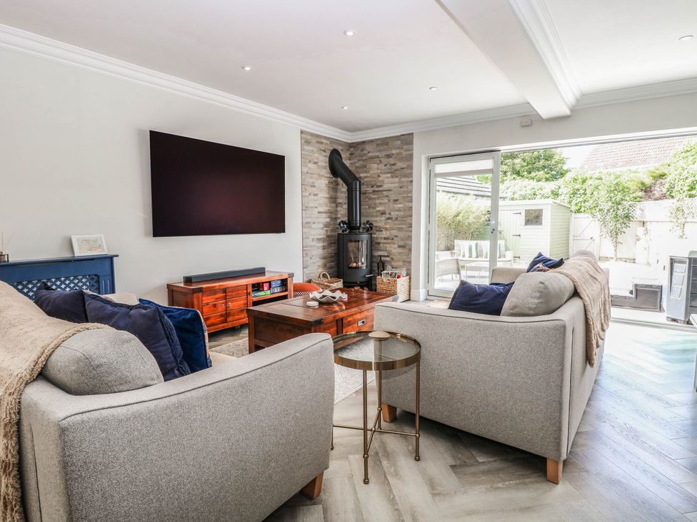 A living room with a fireplace and a television at Cootiya Corner, Great Lyth