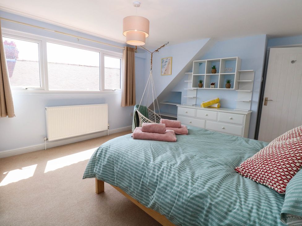 A bedroom with a bed and shelves at Cootiya Corner in Great Lyth