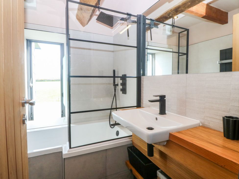 A bathroom with a sink and shower at Seren Fach Pwllheli