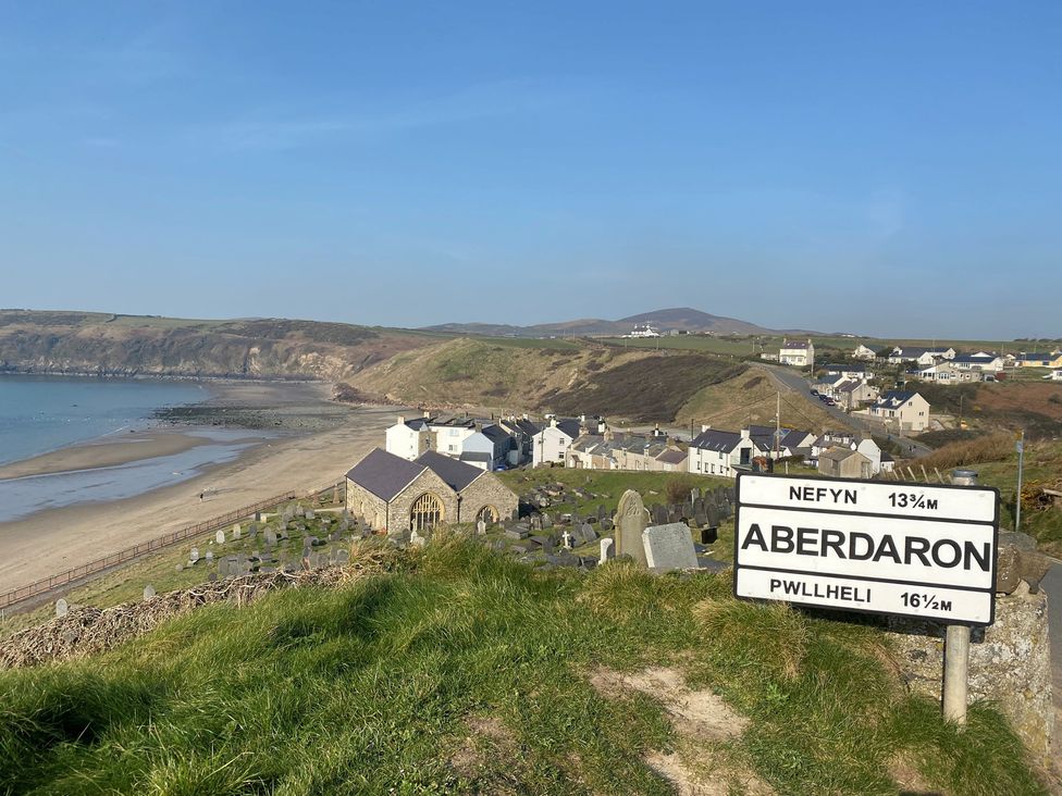 A coastal scene with a sign and graves at Seren Fach near Aberdaron