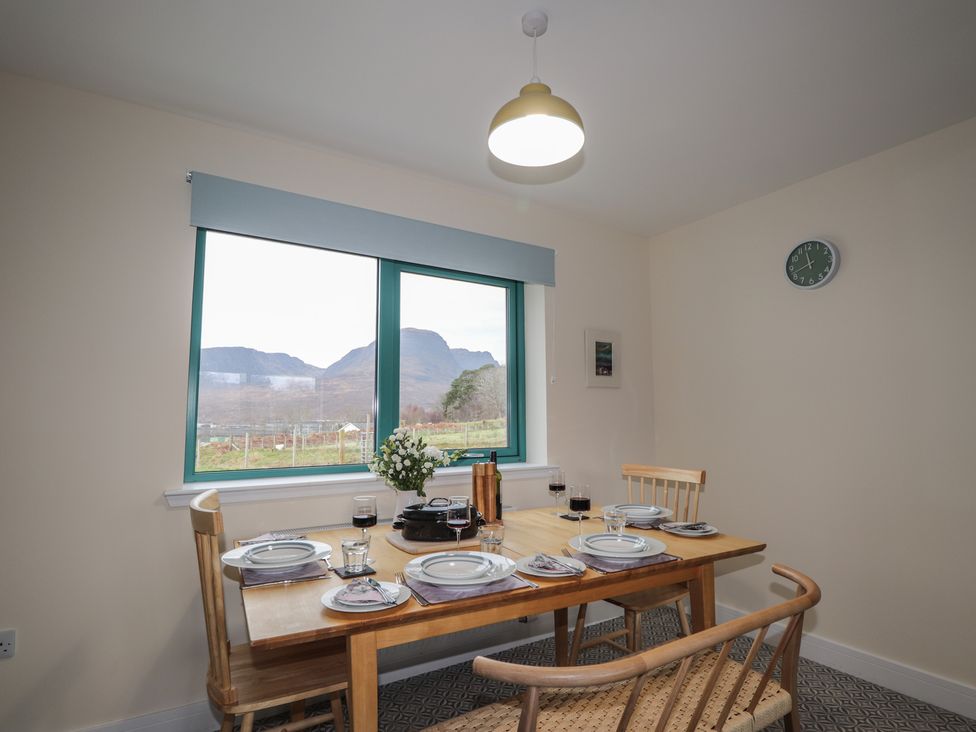A dining room with a table and chairs at Sonas in Strathcarron