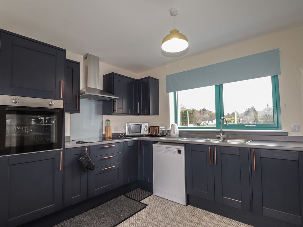 A kitchen with appliances and cabinets at Sonas in Strathcarron