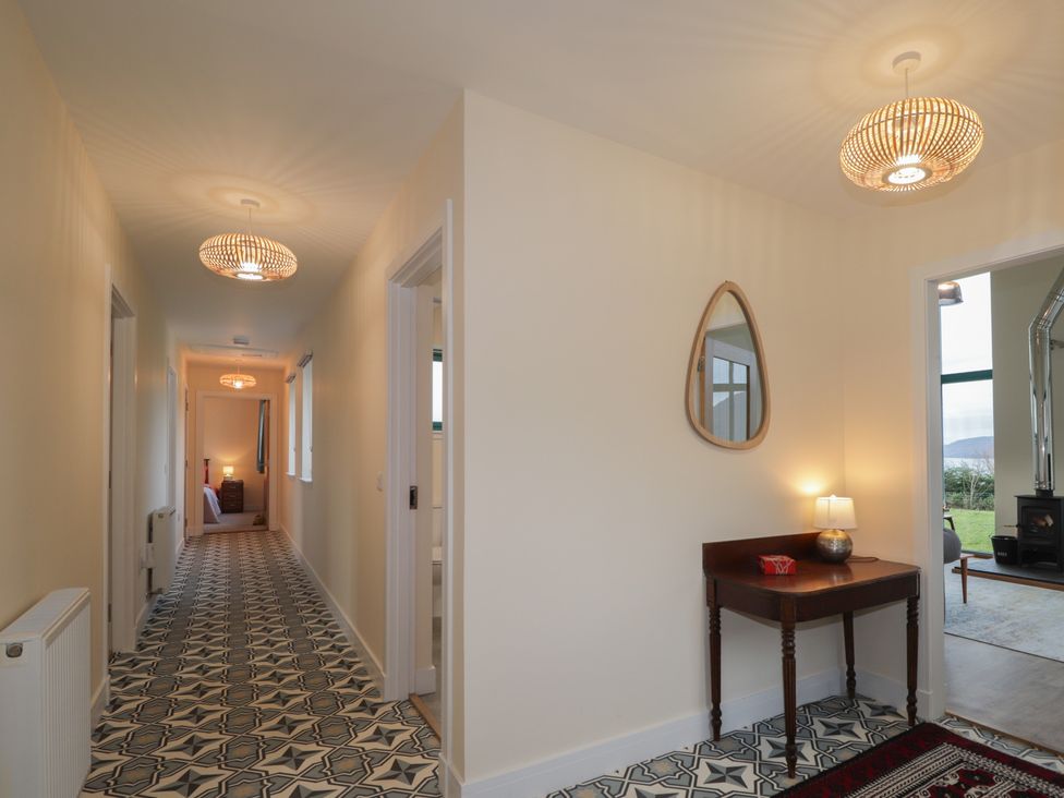 A hallway with a console table and light fixtures at Sonas in Strathcarron