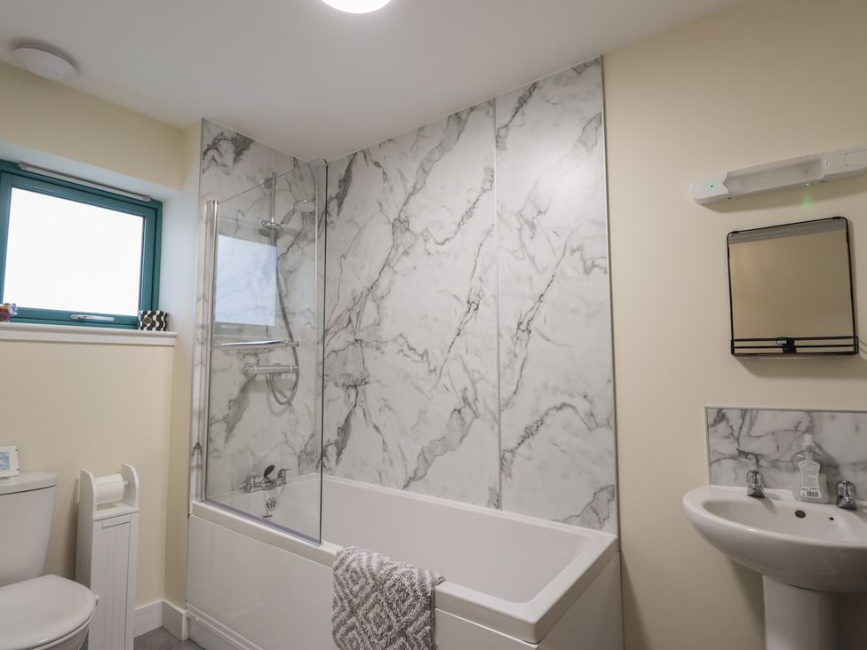 A bathroom with a bathtub, sink, and shower at Sonas in Strathcarron