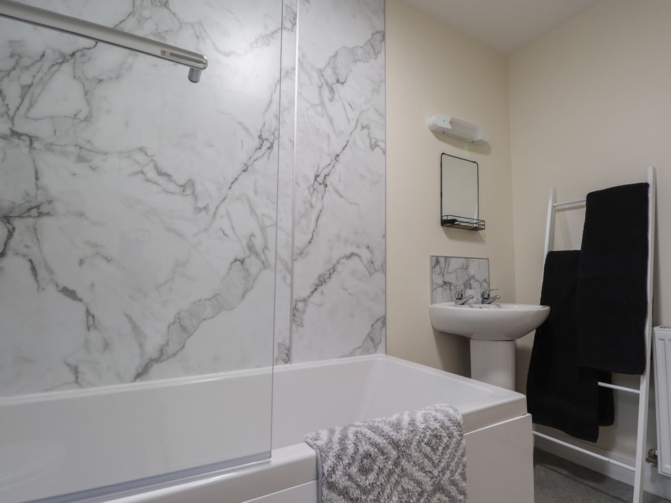 A bathroom with a bathtub and sink at Sonas in Strathcarron