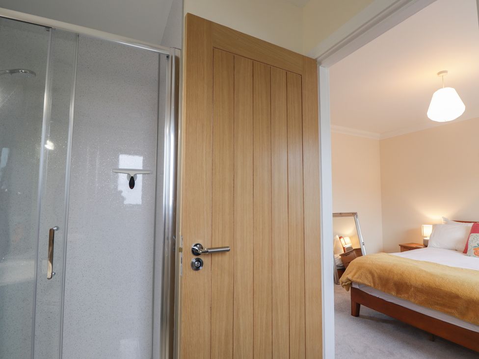 A bathroom leading to a bedroom with a shower and bed at Sonas in Strathcarron