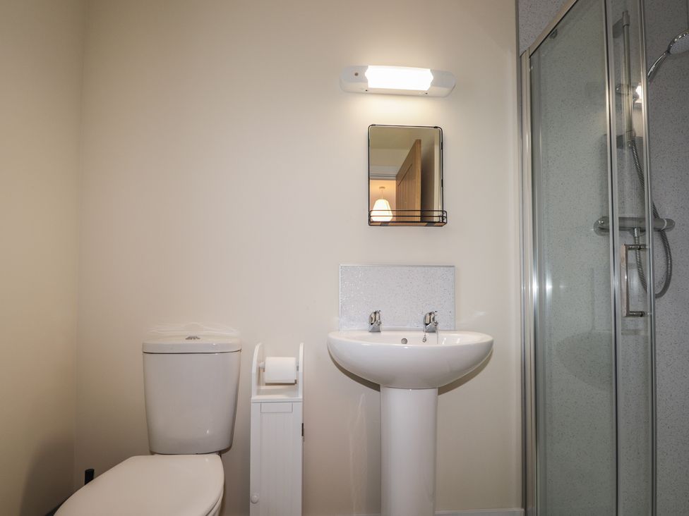 A bathroom with a sink, toilet, and shower at Sonas in Strathcarron