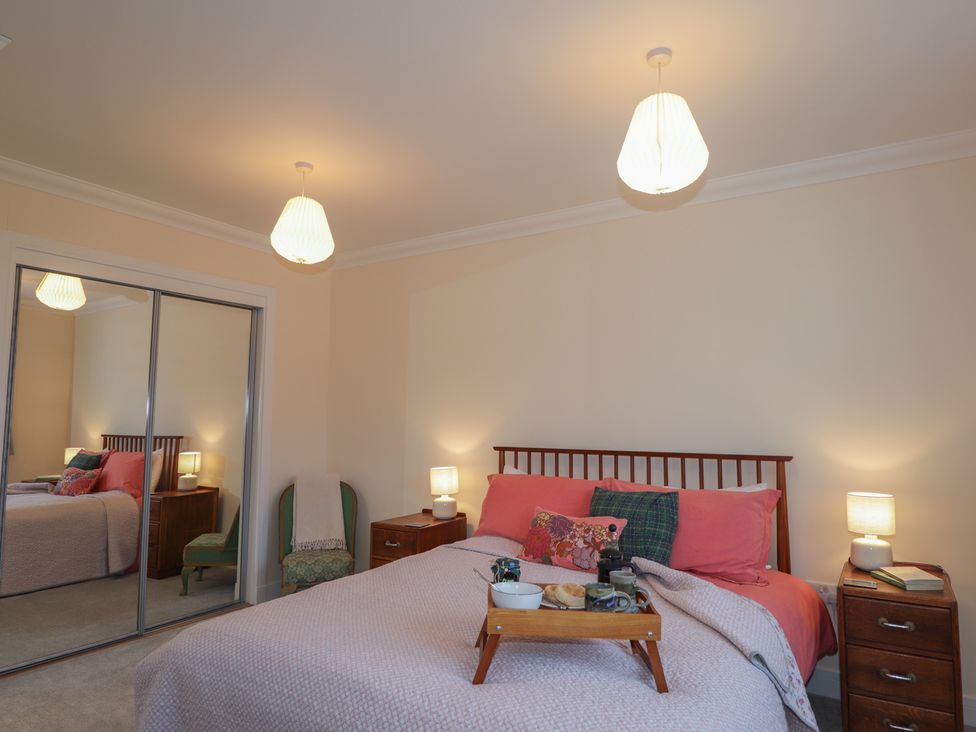 A bedroom with a bed and nightstands at Sonas in Strathcarron