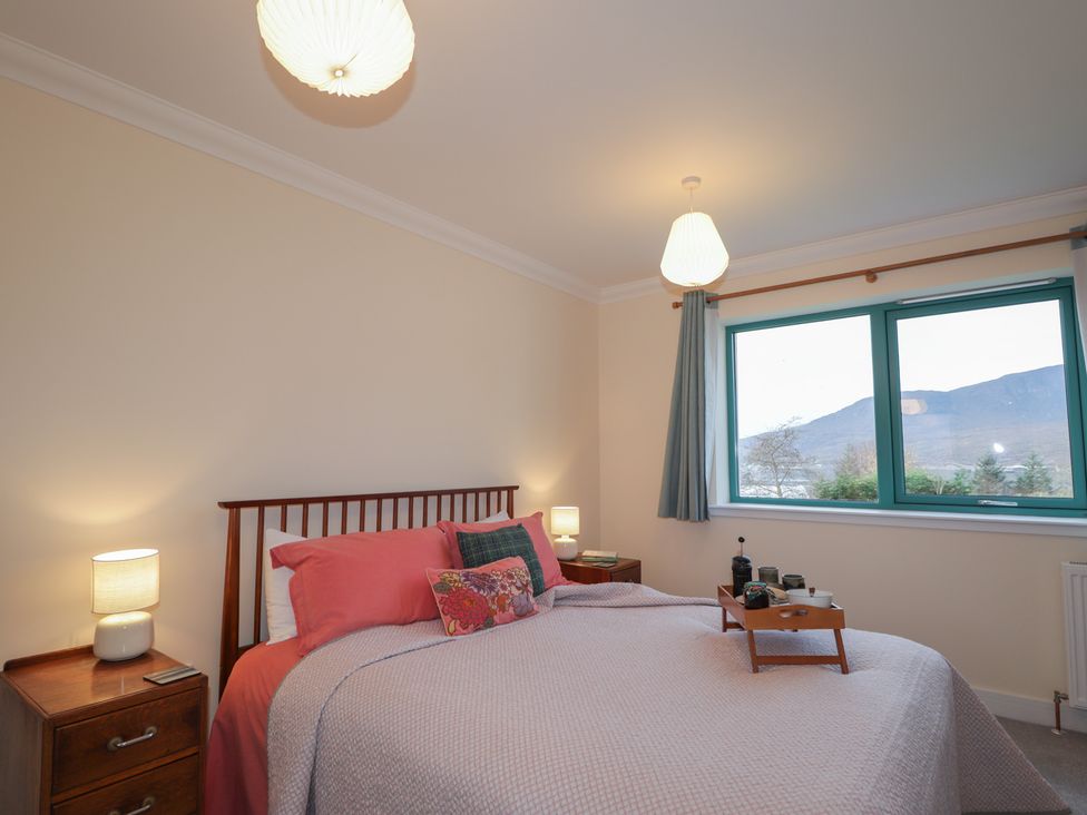 A bedroom with a bed and nightstand at Sonas in Strathcarron