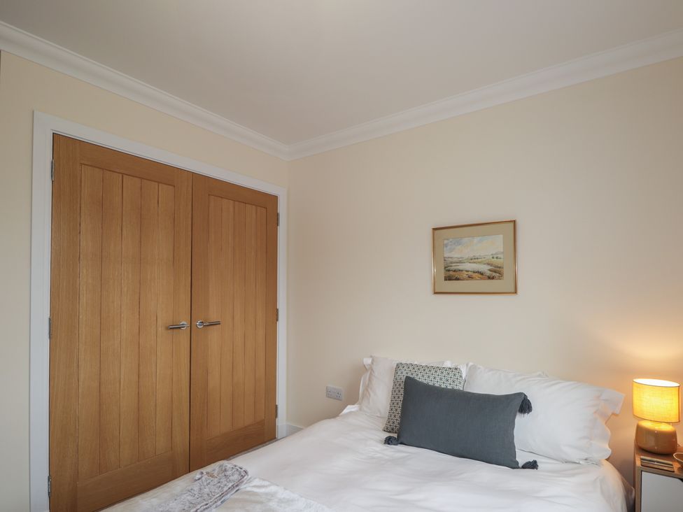 A bedroom with a bed and wardrobe at Sonas in Strathcarron