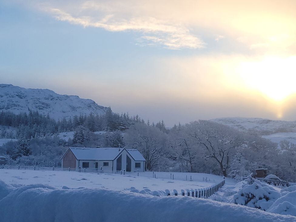 A house and trees in snow at Sonas Lochcarron