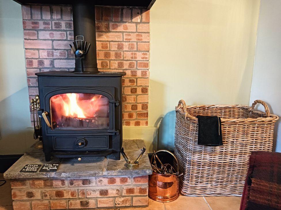 A wood stove with a brick wall at Claymires in Stirling