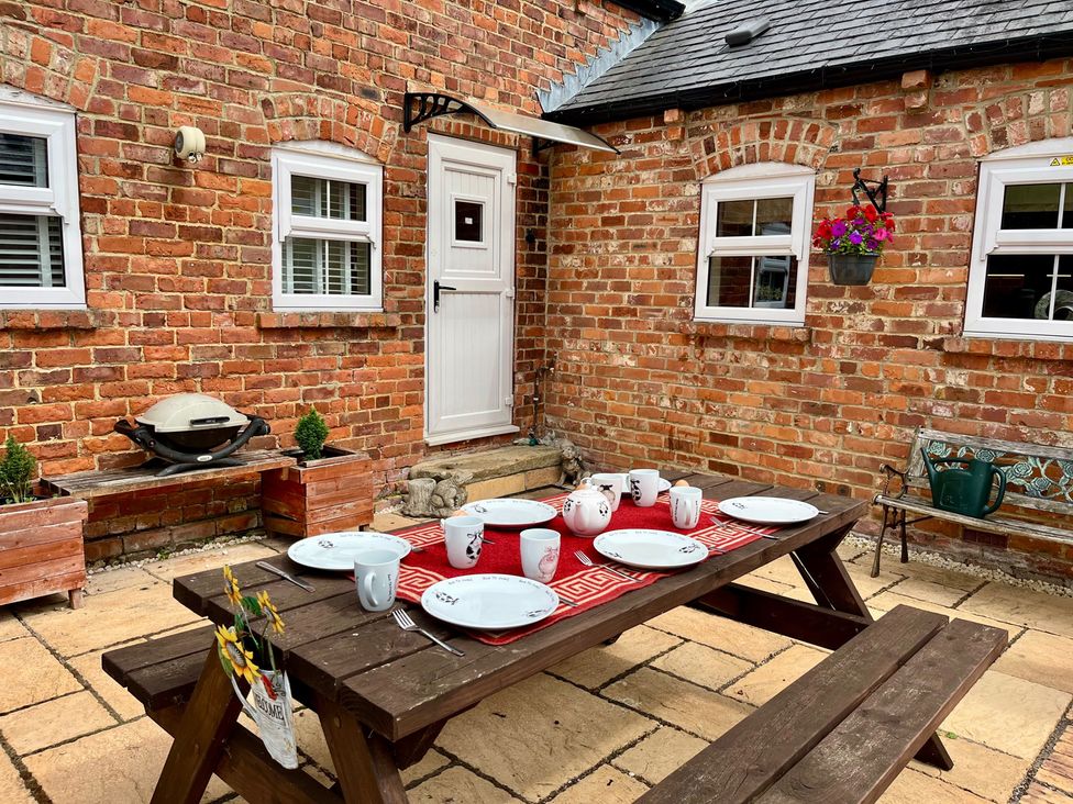 An outdoor patio with a table set for tea at Starshinezzz in Trimdon Station