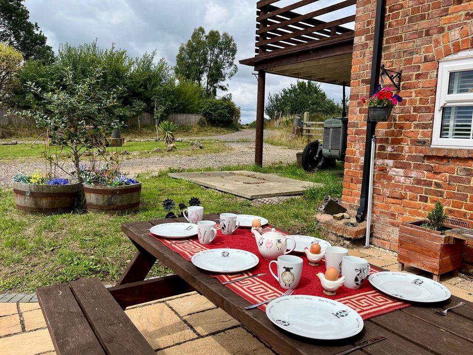 A table set with plates and cups in a garden at Starshinezzz in Trimdon Station