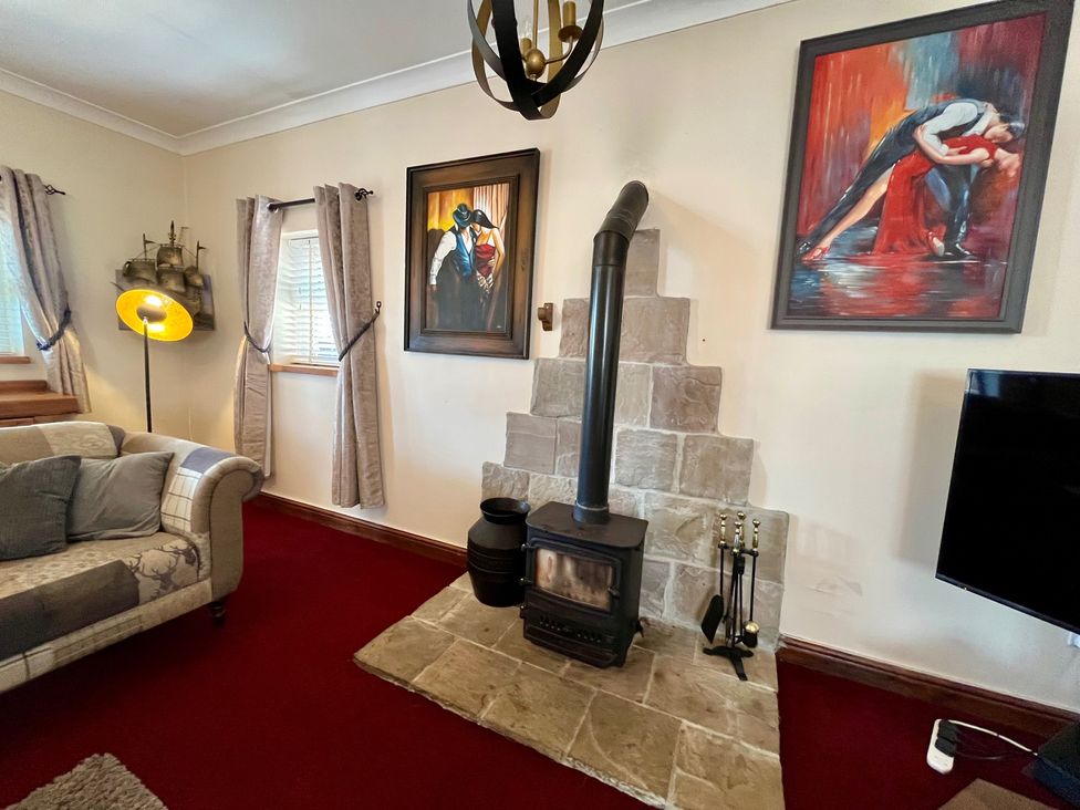 A living room with a sofa and a fireplace at Starshinezzz Trimdon Station