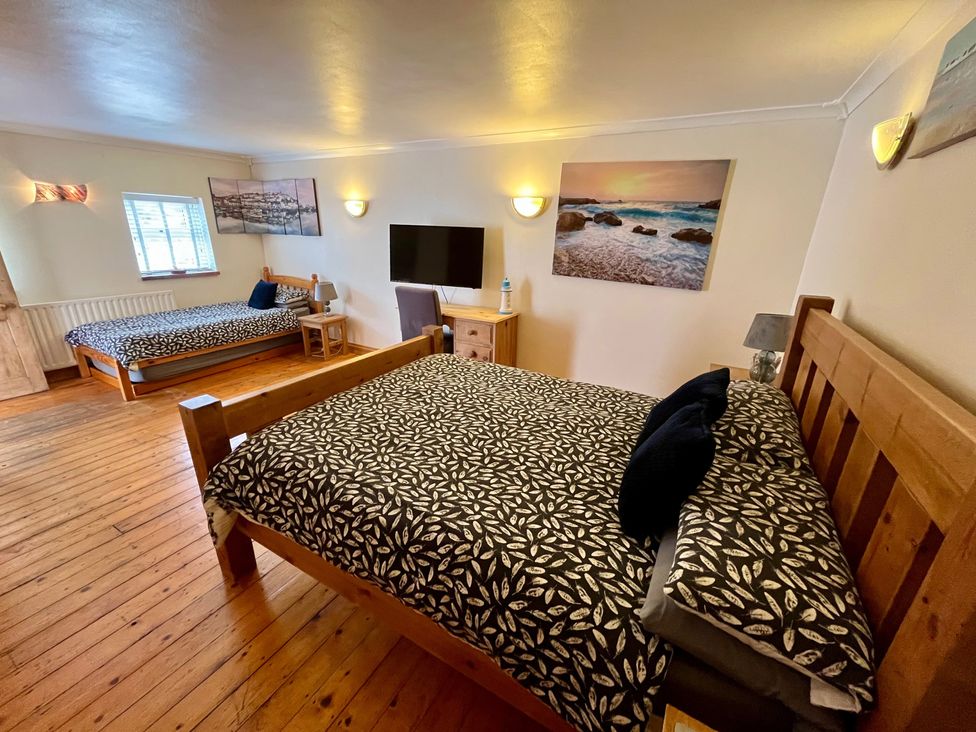 A bedroom with two beds and a TV at Starshinezzz in Trimdon Station