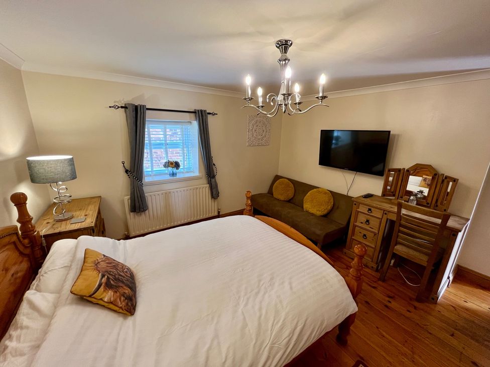 A bedroom with a bed and a television at Starshinezzz in Trimdon Station