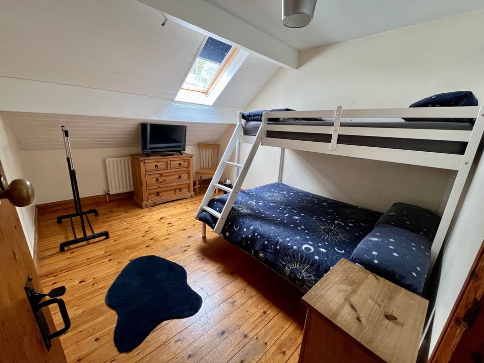 A bedroom with a bunk bed and television at Starshinezzz in Trimdon Station