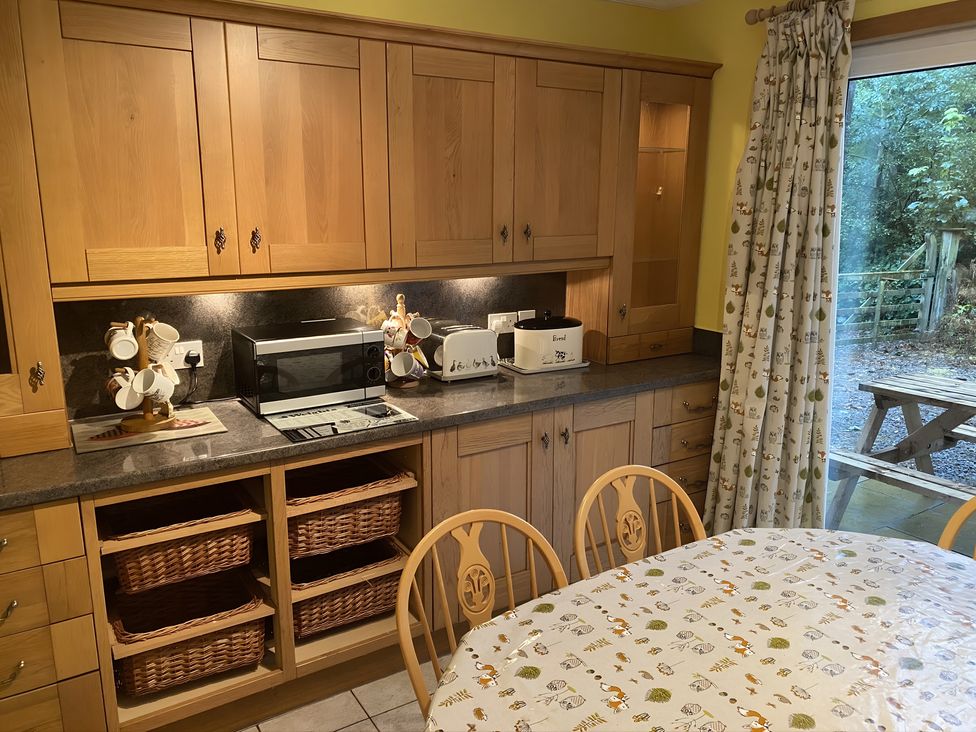 A kitchen with a microwave and toaster at Whispering Trees Cottage in Thornhill