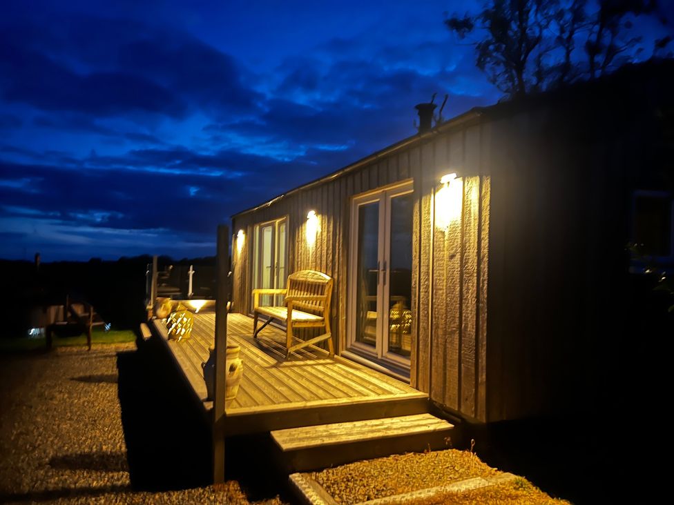 An outdoor area with lighting and seating at The lodge at Plumstone View in Haverfordwest