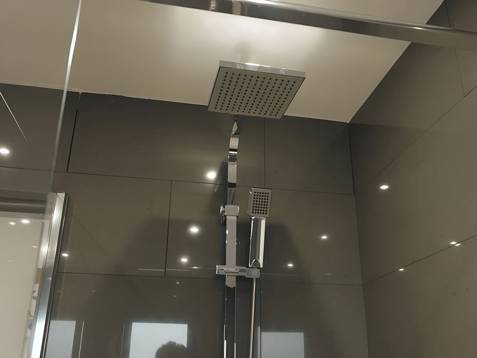 A shower area with shower head and faucet at The lodge at Plumstone View Haverfordwest