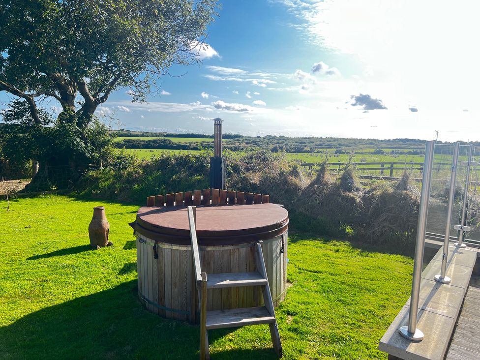A hot tub and garden area at The lodge at Plumstone View in Haverfordwest