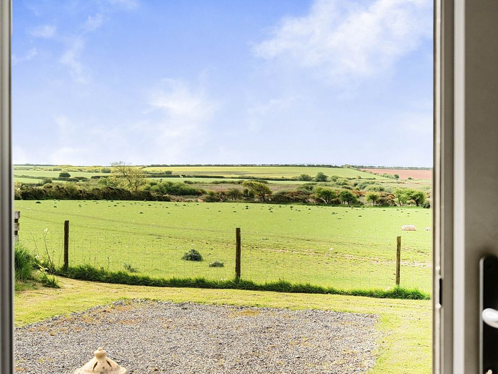 A scenic view of a green field with a fence at The lodge at Plumstone View in Letterston