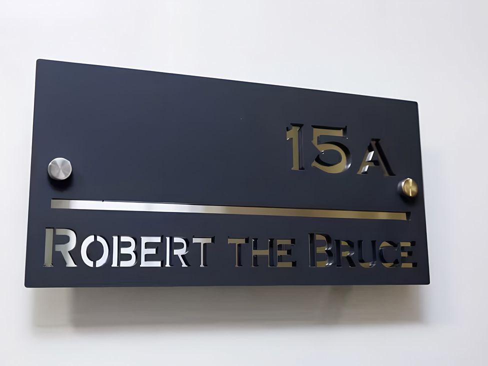 A nameplate with the text 15A Robert the Bruce Apartment in Dunfermline