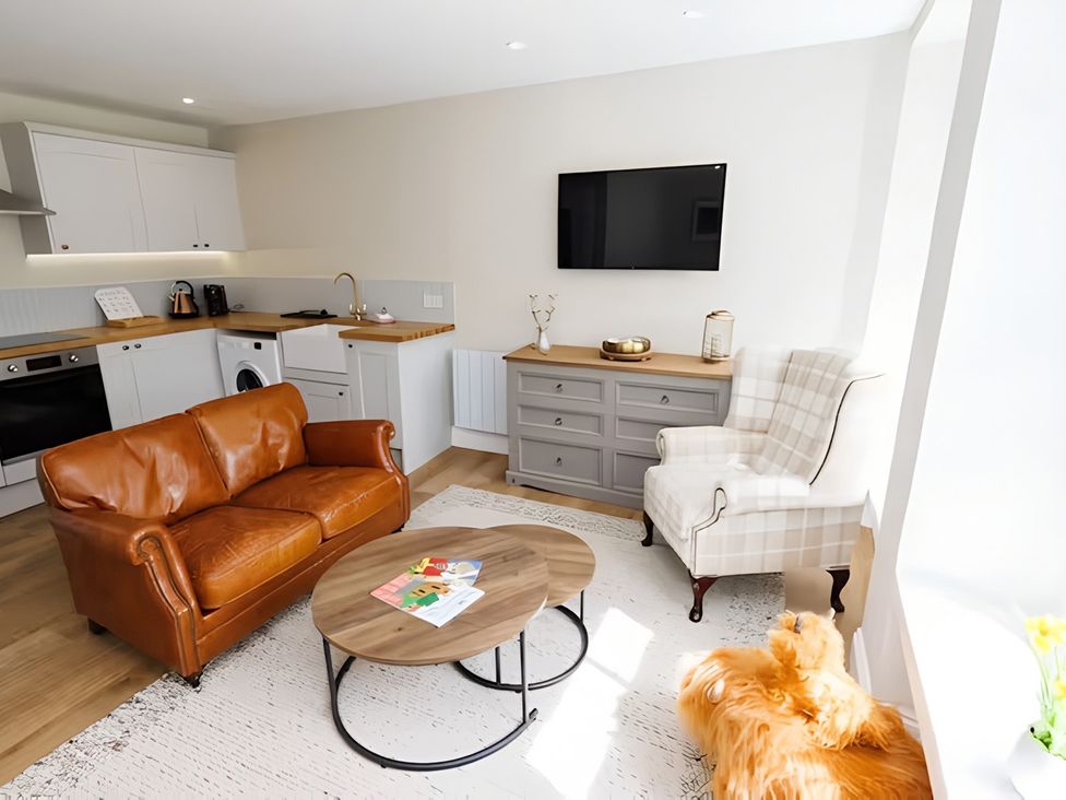 A living room with a sofa and coffee table at Robert the Bruce Apartment in Dunfermline