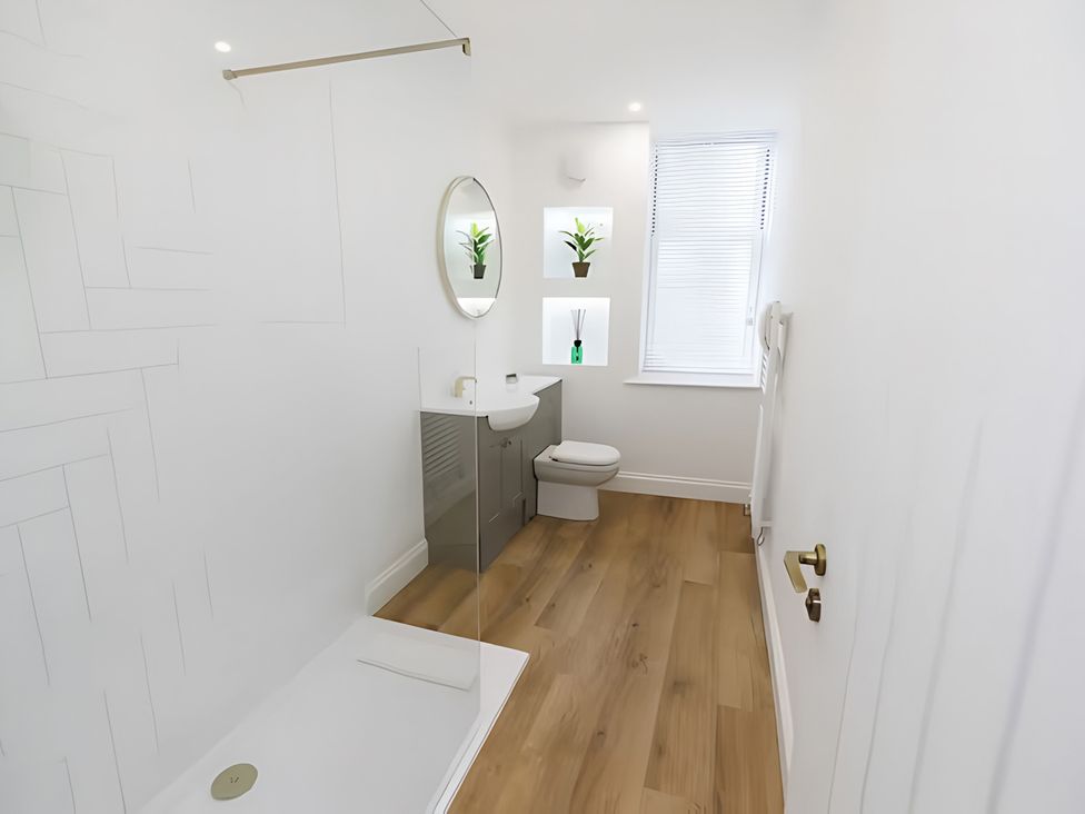 A bathroom with a tub, toilet, and sink at Robert the Bruce Apartment in Dunfermline