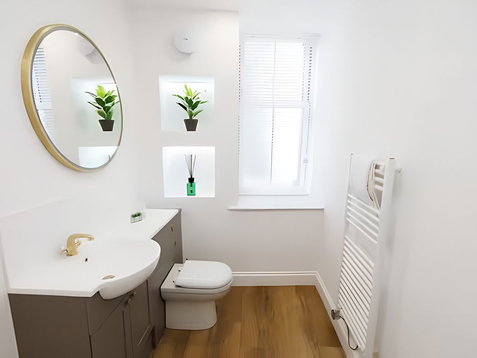 A bathroom with a sink and toilet at Robert the Bruce Apartment in Dunfermline