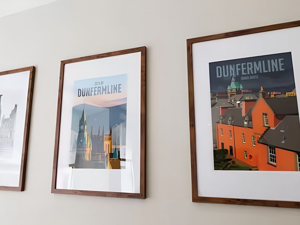 Framed posters of Dunfermline city displayed on a wall at Robert the Bruce Apartment in Dunfermline