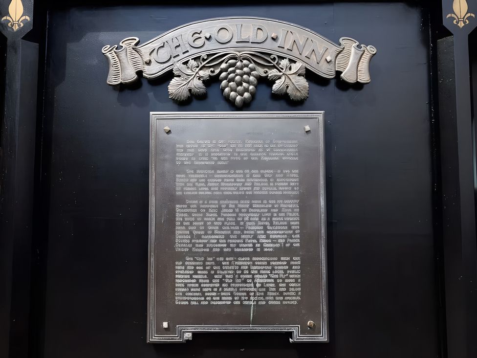 A plaque with text and decorative elements at The Old Inn in Dunfermline