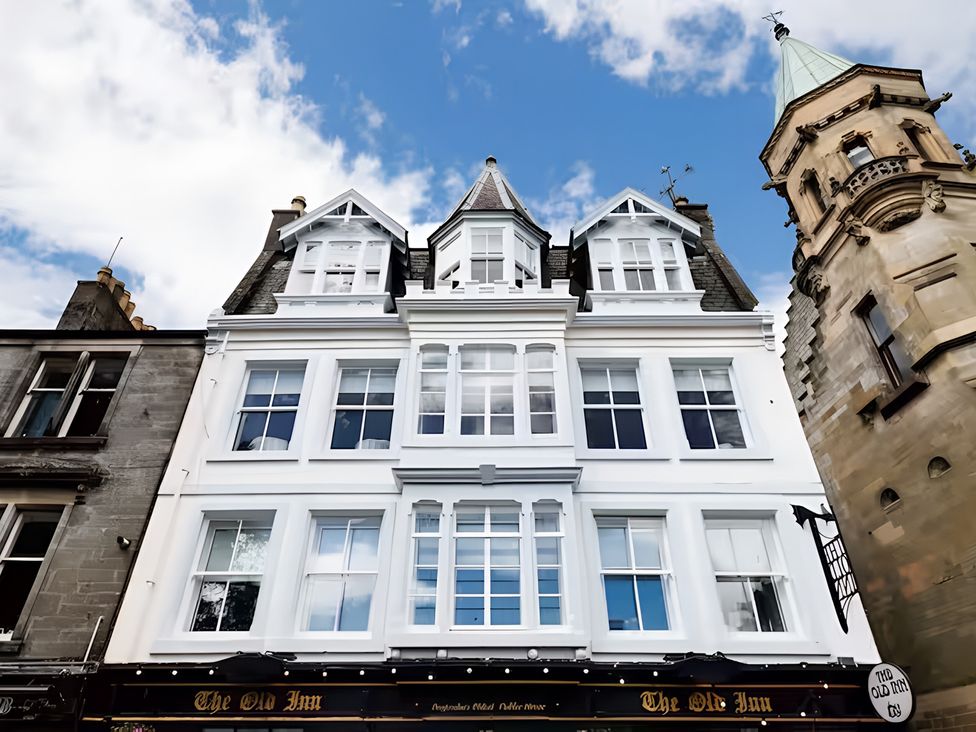 A building exterior with windows and signage at The Old Inn in Dunfermline