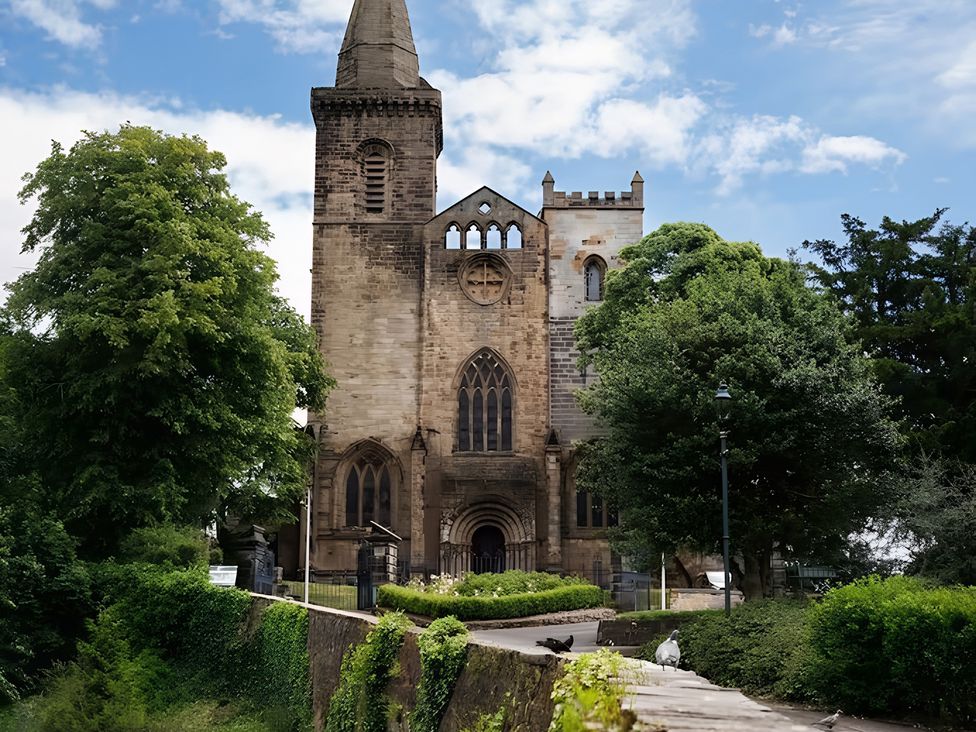A church building with trees and a path at Robert the Bruce Apartment in Dunfermline
