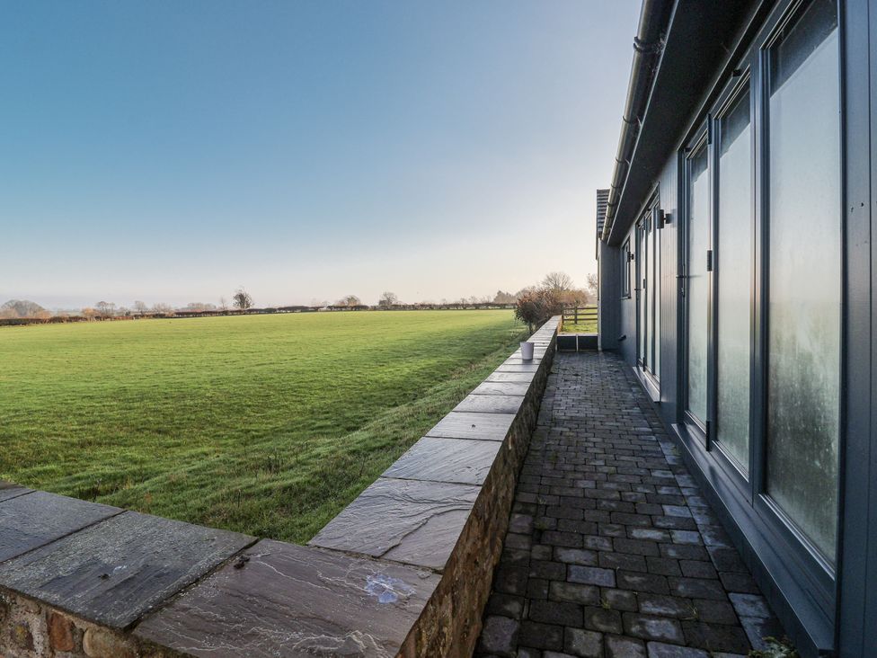 An outdoor area with a stone pathway and a grass field at Genesis in Richmond