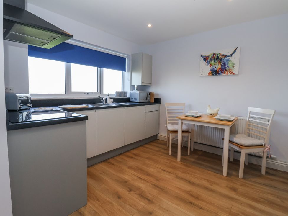 A kitchen with a table and chairs at Genesis in Richmond