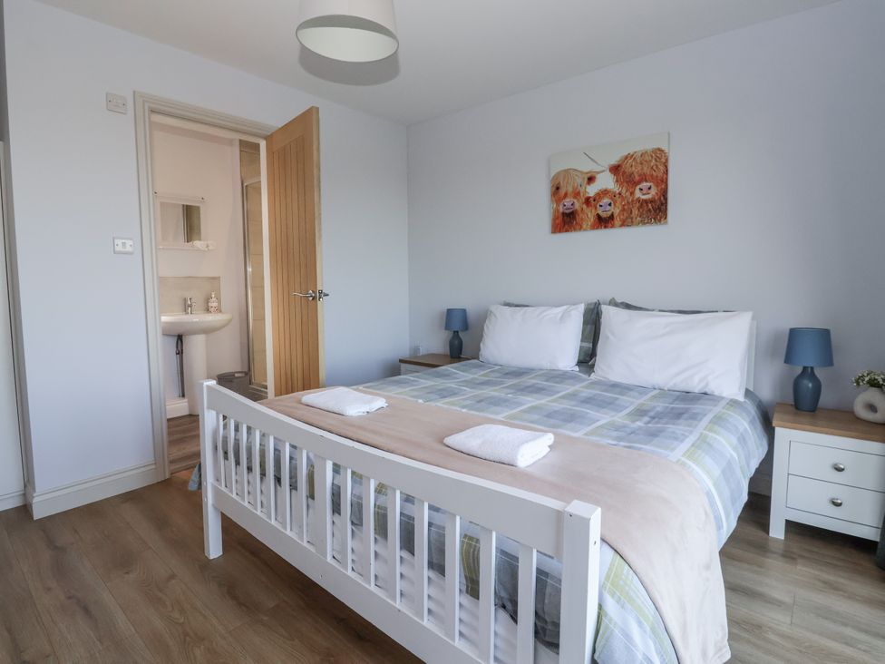 A bedroom with a bed and bathroom door at Genesis in Richmond