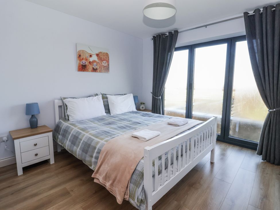 A bedroom with a bed and nightstand at Genesis in Richmond