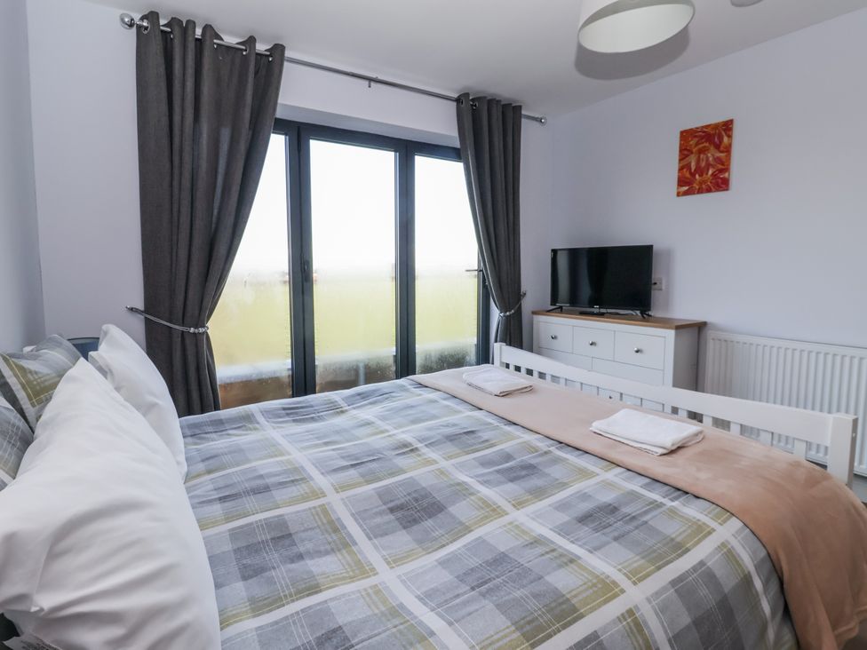 A bedroom with a bed and television at Genesis in Richmond