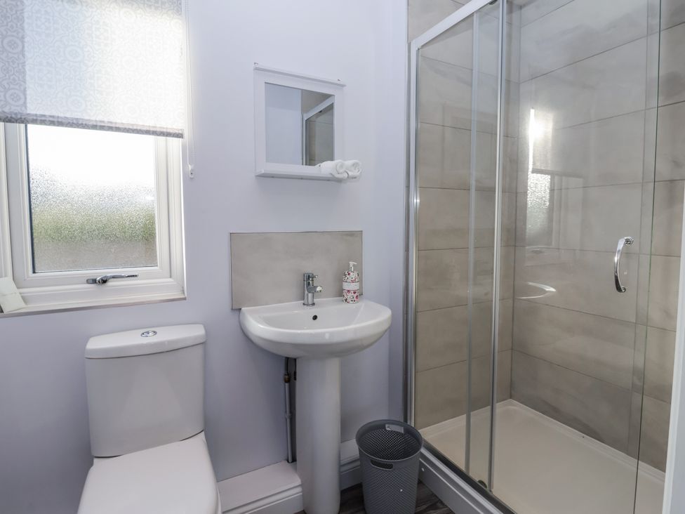 A bathroom with a shower and sink at Genesis in Richmond