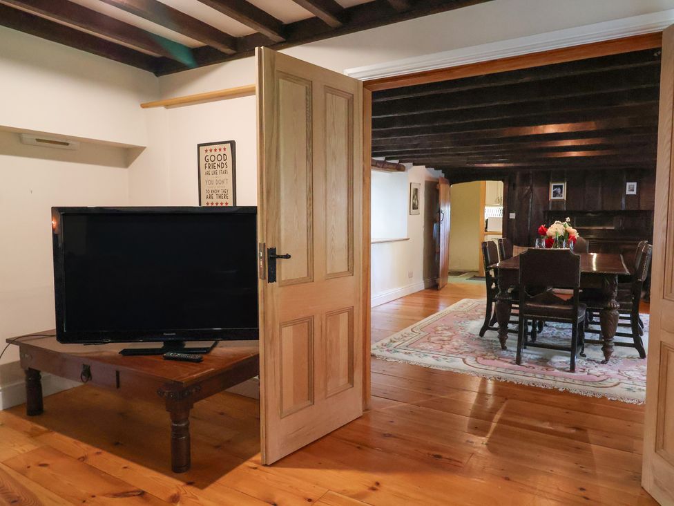 A dining room with a wooden table and chairs at Ellishayes Farm in Combe Raleigh