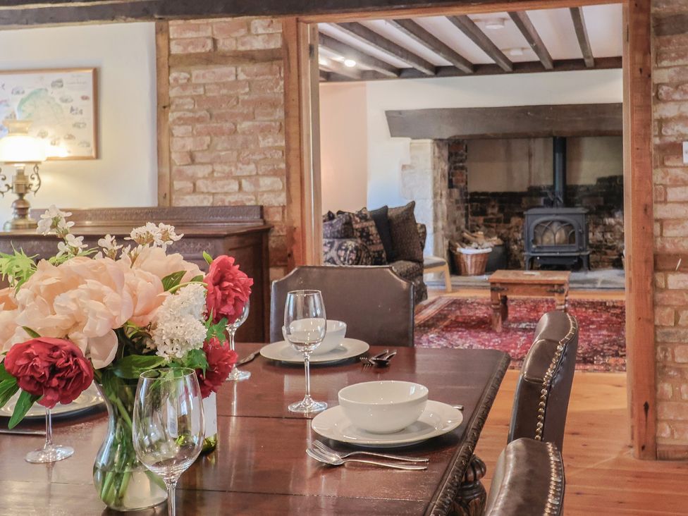 A dining room with a table set for dinner at Ellishayes Farm in Combe Raleigh