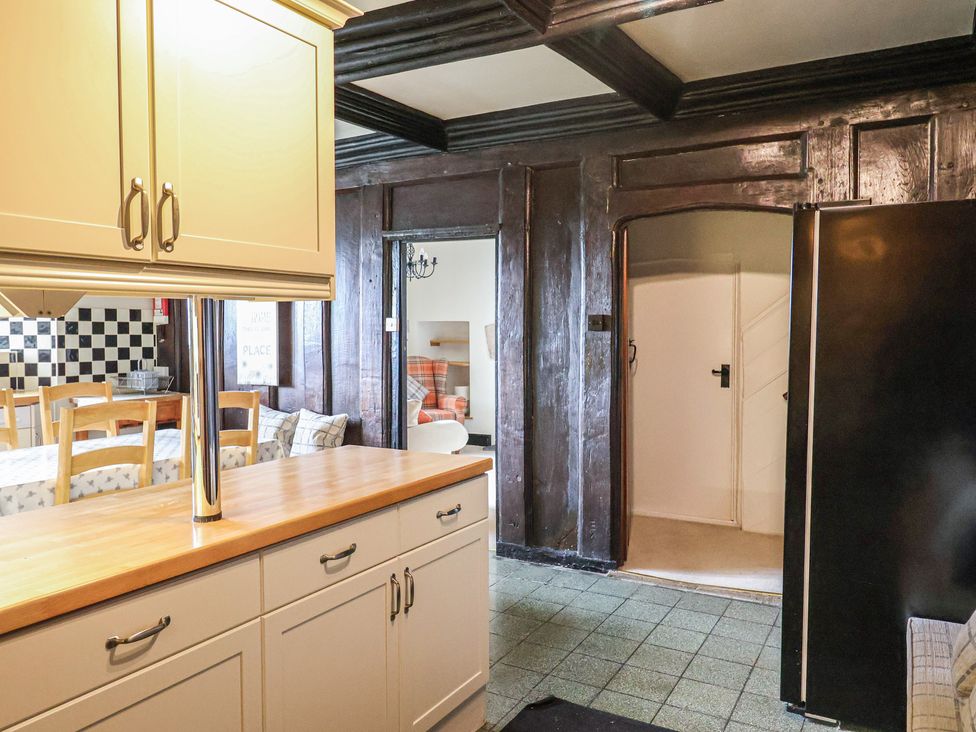 A kitchen with cabinets and a table at Ellishayes Farm in Combe Raleigh